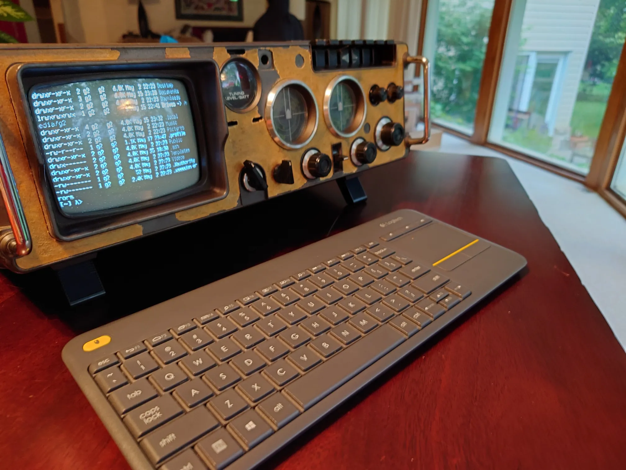 The final TV looking like a small personal computer with a keyboard in front of it